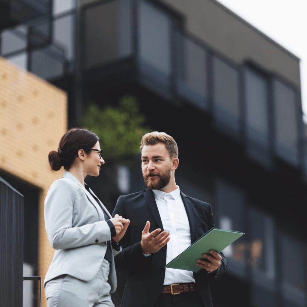 men and woman talking buisiness. Picture used to explain how to grow your real state business